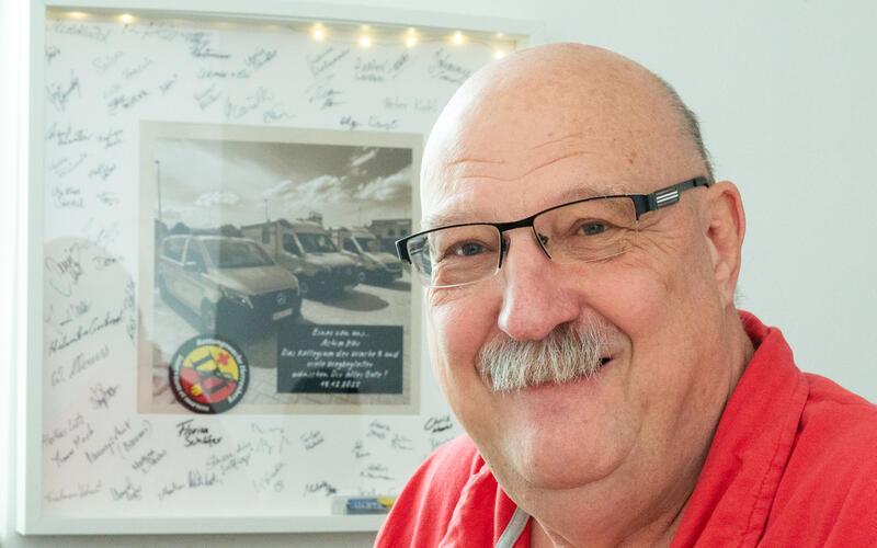 Achim Här fährt auch als Rentner weiter Einsätze. Im Hintergrund das Abschiedsgeschenk von seinen Kollegen. GB-Foto: Vecsey