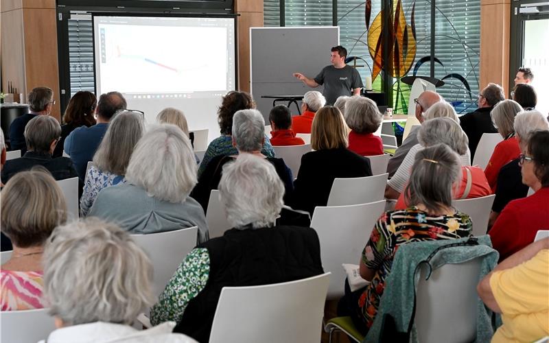 Daniel Duperon Quezadas, Leiter Netze und Betriebsanlagen bei den Stadtwerken Herrenberg (stehend), erklärt bei der Quartiersversammlung den interessiert lauschenden Betroffenen das Vorgehen bei der Baustelle in der Beethovenstraße. GB-Foto: Holom