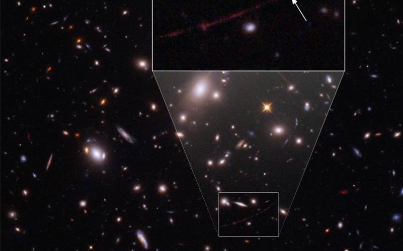 Der Stern mit dem Namen „Earendel“ liegt hinter einem Galaxienhaufen, der als Gravitationslinse dient. Foto: Space Telescope Science Institut/ESA/Hubble/dpa