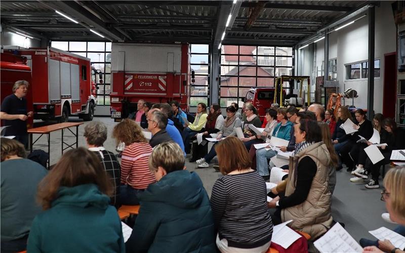 Gärtringen – Mit großer Unterstützung der Feuerwehr Gärtringen fand die erste Probe des Projektchores „diestimmbande on Fire“ in der hinteren Halle des Feuerwehrhauses statt. Die Organisatoren des Projekts waren über die große Resonanz begeistert. „Dass das Interesse so groß ist, hätte ich nicht erwartet. Ich freue mich sehr darüber“, teilt Rita Geuder mit, die im Team rund um die Öffentlichkeitsarbeit beim Sängerkranz mitarbeitet. Begrüßt wurden die rund 45 Sängerinnen und Sänger zu Beginn vom Abteilungskommandanten der Feuerwehr, Markus Gaal, und dem Vorsitzenden des Sängerkranzes, Martin Burichter. Chorleiter Wolfgang Körber dirigierte den Stammchor und knapp 20 weitere Interessenten durch eine lockere erste Probe, die mit einem kurzen Umtrunk endete. Das Fazit derjenigen, die zum ersten Mal dabei waren: „Ich komme wieder.“ „Wer sich noch kurzfristig entschließt mitzumachen, kann gerne noch dazustoßen“, erklärte Martin Burichter. Die Proben finden von nun an mittwochs um 19.30 Uhr im Musiksaal der Heuss-Realschule statt. Weitere Informationen gibt es unter www.diestimmbande.de gb/GB-Foto: gb