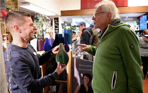Moritz Kleiner (links) präsentiert in seinem Haushaltswarengeschäft Vasen aus dem 3D-Drucker.GB-Foto: Holom