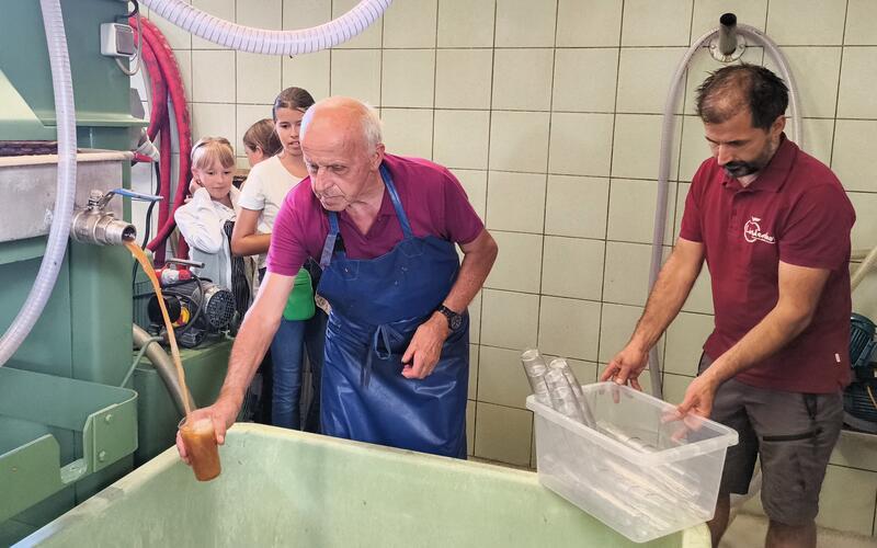 Seniorchef Karl Haischt (links) und Marcus Haischt zapften frisch gepressten Apfelsaft für die Gäste. GB-Foto: Straub